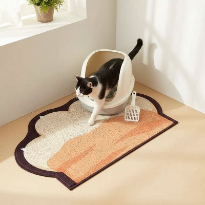 Tapis litière pour chat placé devant un bac ouvert dans un coin de la pièce