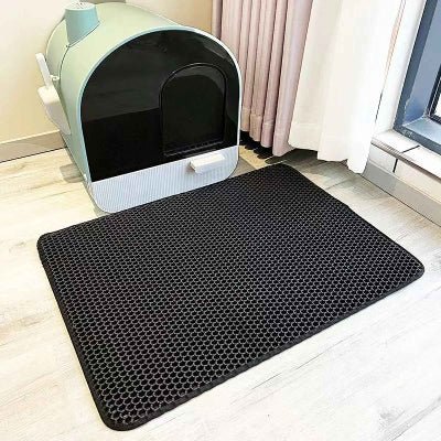 tapis litière chat noir a cote du bac à litière fermé